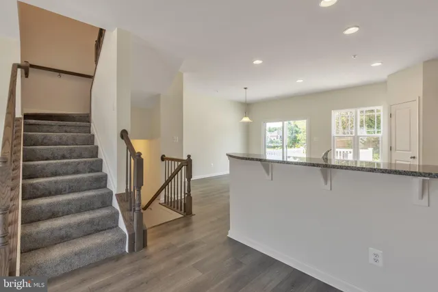 a view of entryway with wooden floor and stairs