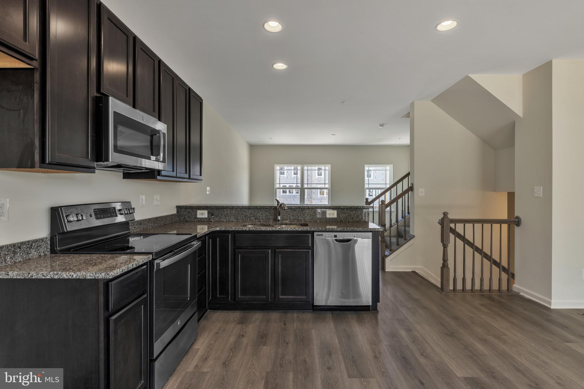 821 Magnolia Ridge Court Joppa, MD 21085 - Photo 15 of 33 a kitchen with stainless steel appliances granite countertop a stove and a sink