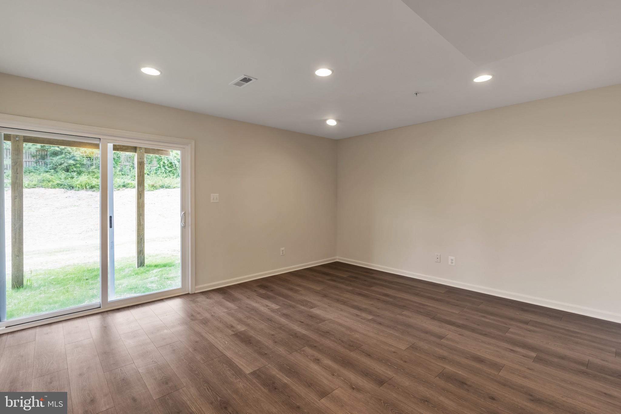 821 Magnolia Ridge Court Joppa, MD 21085 - Photo 4 of 33 a view of an empty room with wooden floor and a window