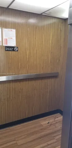 a kitchen with granite countertop white cabinets and stainless steel appliances