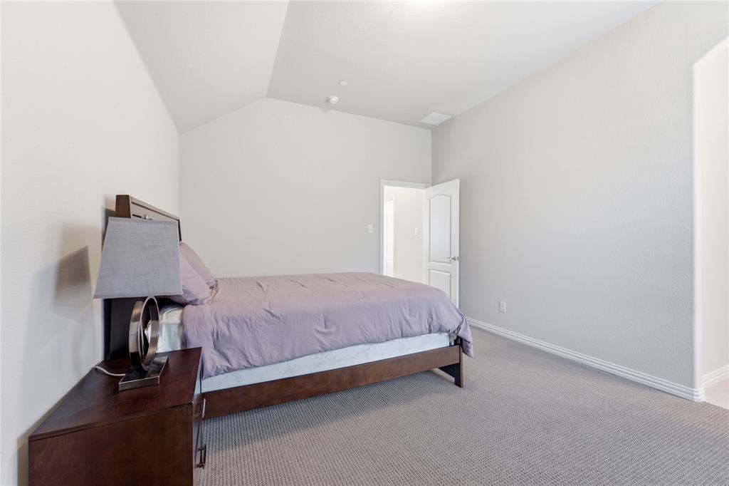 7705 Falcon Ridge Road Denton, TX 76208 - Photo 36 of 40 Bedroom featuring lofted ceiling and carpet floors