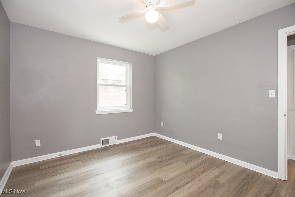 1547 Genesee Road South Euclid, OH 44121 - Photo 12 of 36 Unfurnished room featuring ceiling fan, wood finished floors, and baseboards