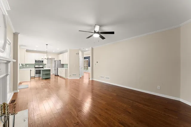 a view of a kitchen with wooden floor and a kitchen