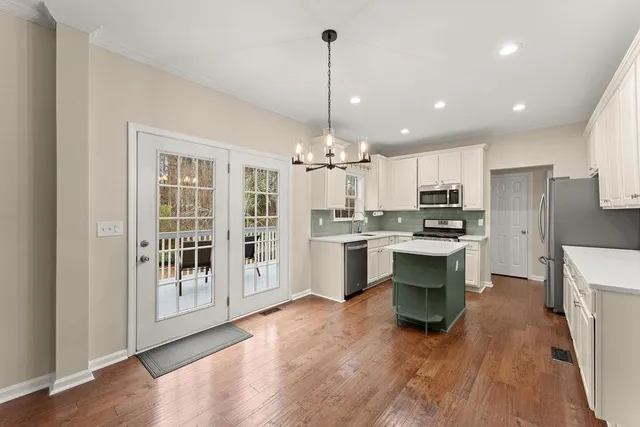 a kitchen with a sink a counter top space stainless steel appliances and cabinets