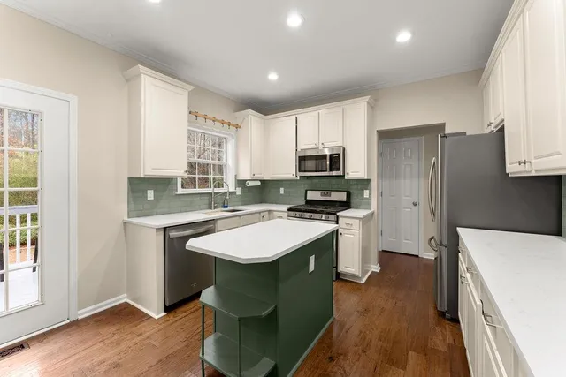 a kitchen with a stove a sink and a refrigerator