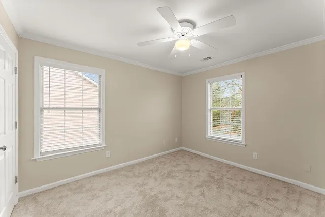 an empty room with fan and a ceiling fan