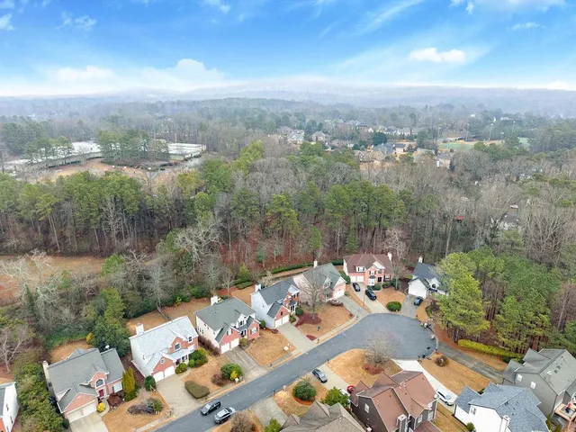 an aerial view of a house with a yard