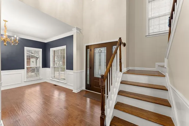 a view of an entryway with wooden floor and windows