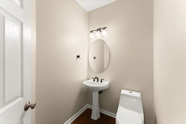 a bathroom with a sink toilet and a mirror