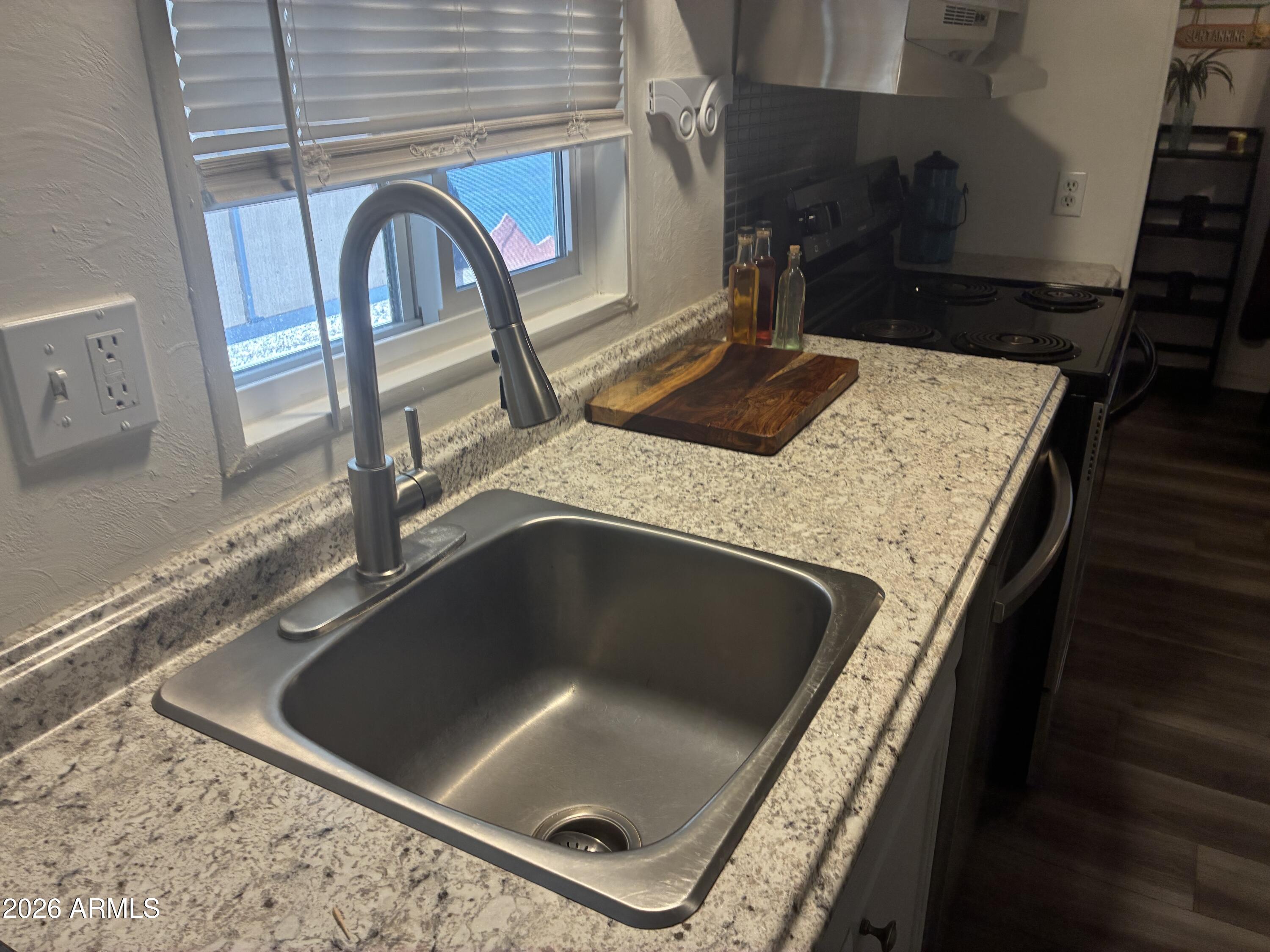53 North Mountain Road, Unit 58 Apache Junction, AZ 85120 - Photo 11 of 39 a kitchen with a sink and a stove