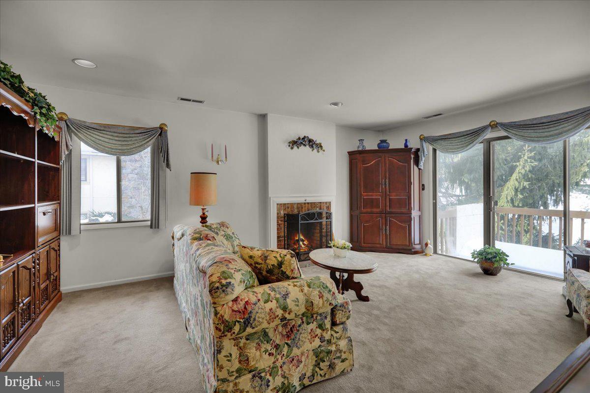 12 Muirfield Drive Reading, PA 19607 - Photo 5 of 18 a living room with furniture a fireplace and a flat screen tv