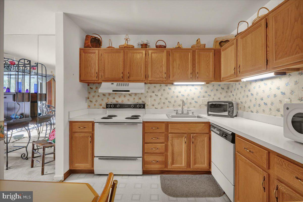 12 Muirfield Drive Reading, PA 19607 - Photo 9 of 18 a kitchen with stainless steel appliances granite countertop a sink a stove and a refrigerator