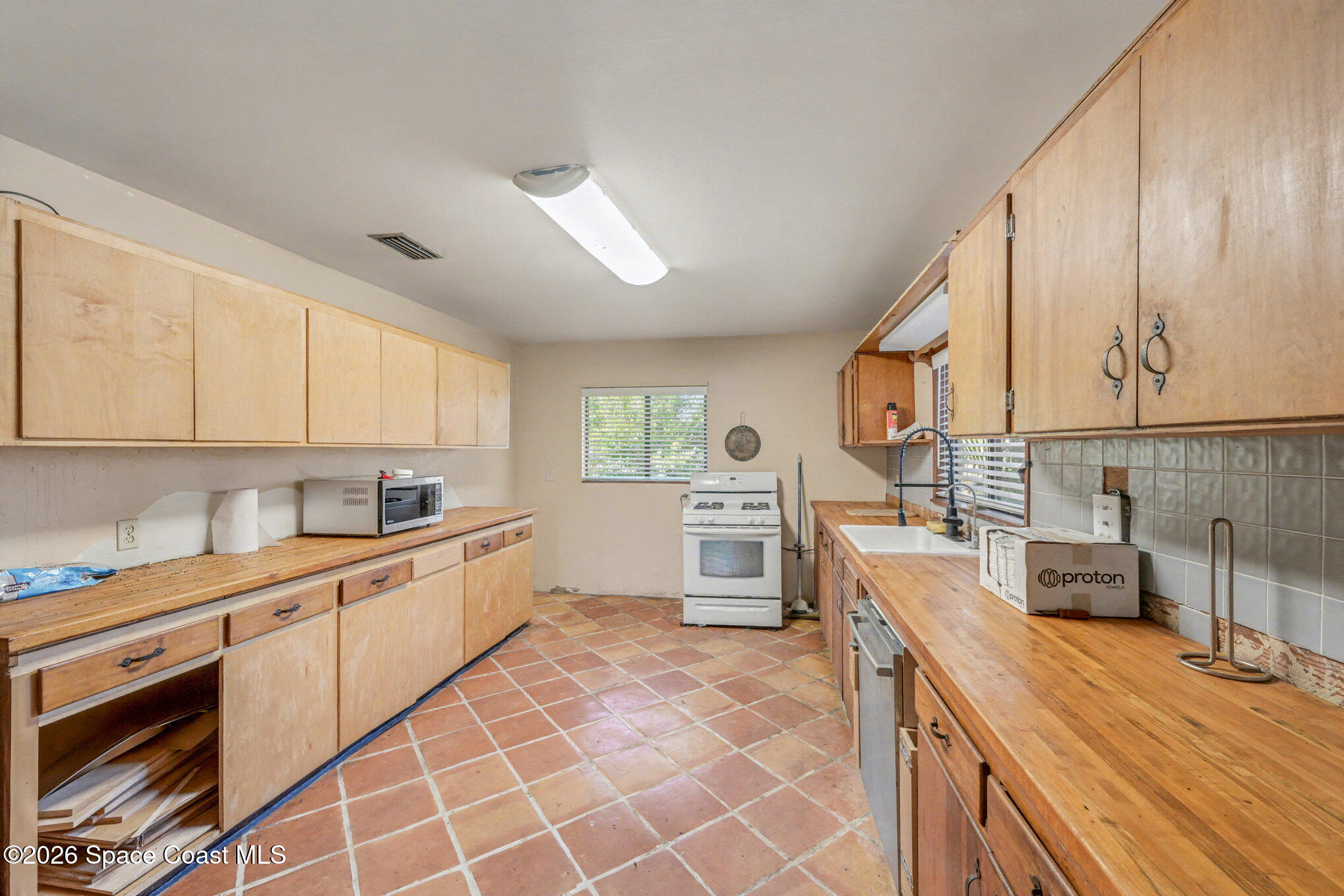 5195 Blounts Ridge Road Mims, FL 32754 - Photo 11 of 28 a kitchen with a sink a stove and cabinets