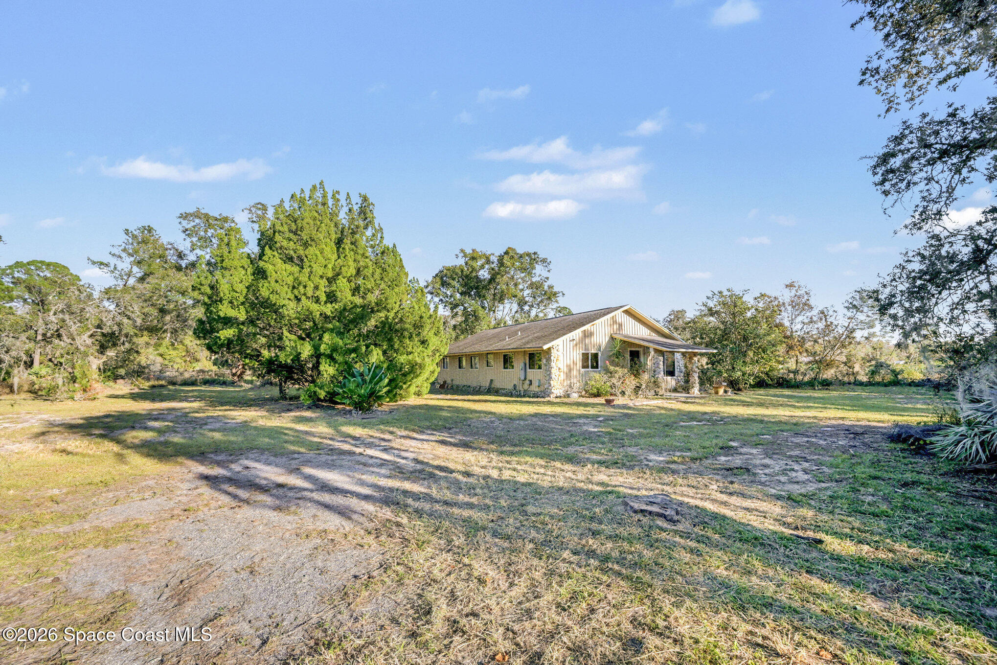 5195 Blounts Ridge Road Mims, FL 32754 - Photo 6 of 28 a front view of a house with a yard and trees