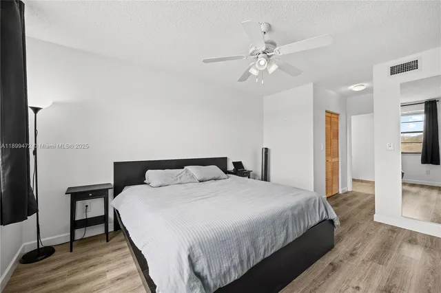 a bedroom with a large bed and a chandelier