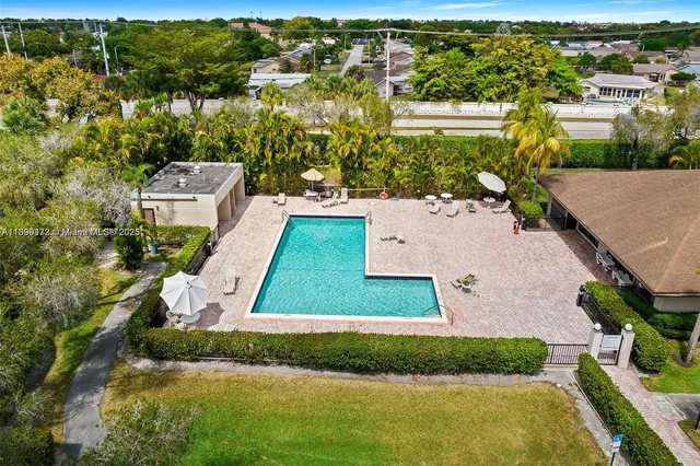an aerial view of residential houses with yard