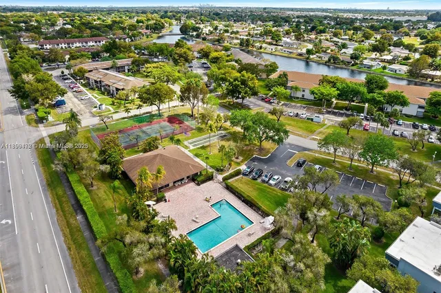 an aerial view of residential houses with outdoor space