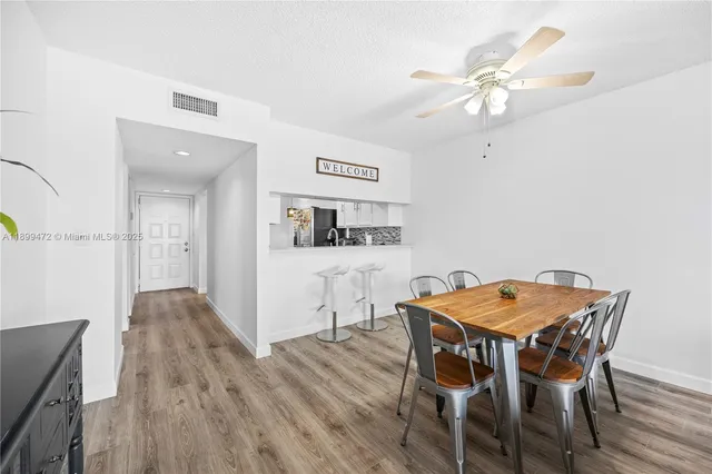 a view of a dining room with furniture and wooden floor