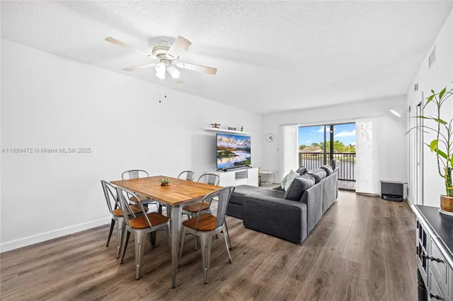 a living room with furniture a chandelier and a window