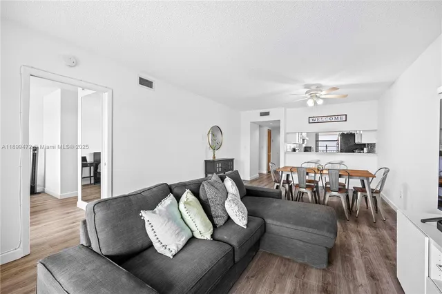 a living room with furniture and wooden floor
