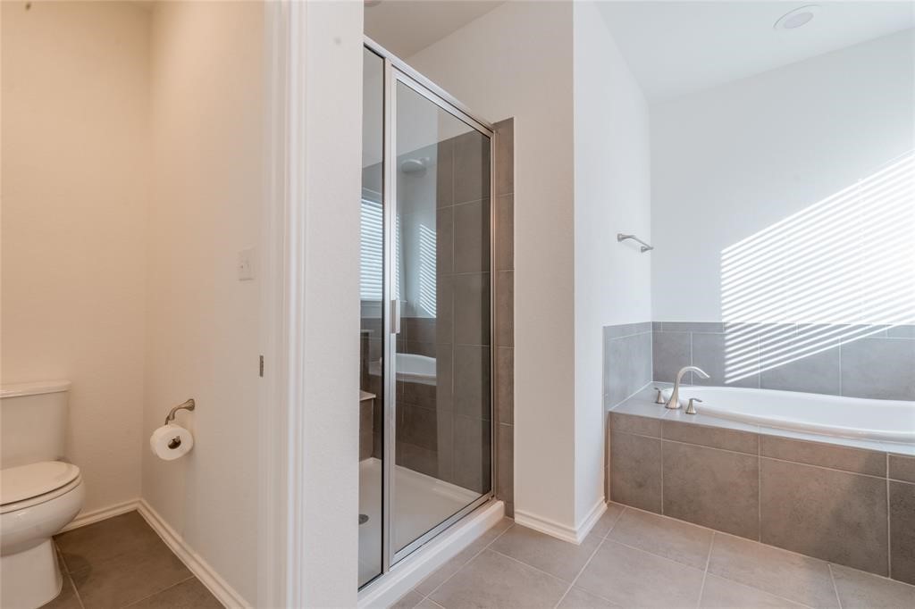 1333 Terrace View Drive Georgetown, TX 78628 - Photo 29 of 35 Indulge in a tranquil retreat featuring a deep soaking tub and a sleek glass-enclosed shower.