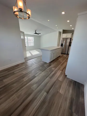 a kitchen with granite countertop white cabinets and white appliances