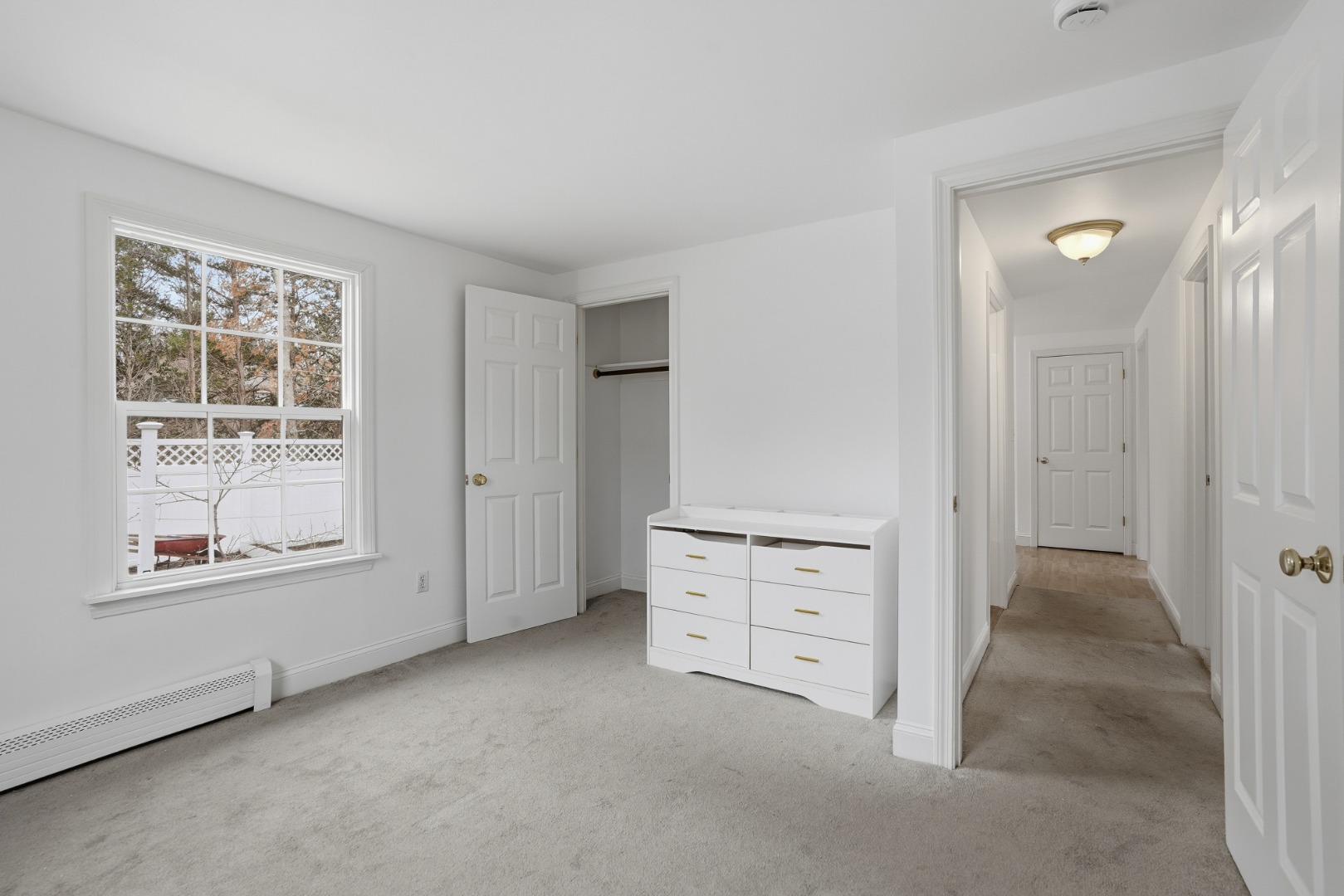 67 12th Street Edgartown, MA 02539 - Photo 18 of 26 an empty room with cabinet and windows