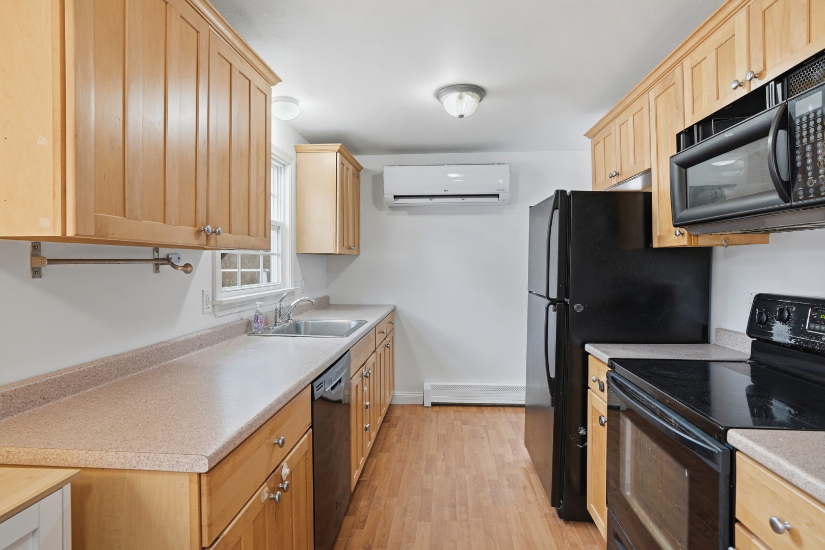 67 12th Street Edgartown, MA 02539 - Photo 6 of 26 a kitchen with stainless steel appliances granite countertop a sink stove and refrigerator