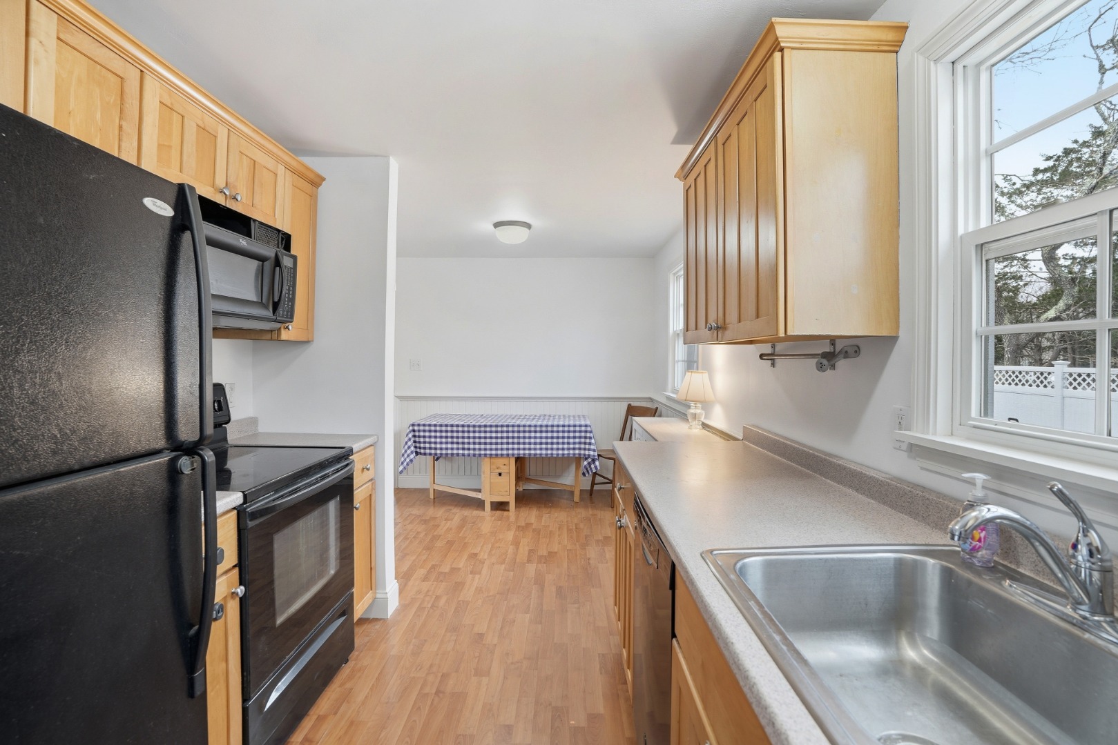 67 12th Street Edgartown, MA 02539 - Photo 8 of 26 a kitchen with a refrigerator and a sink