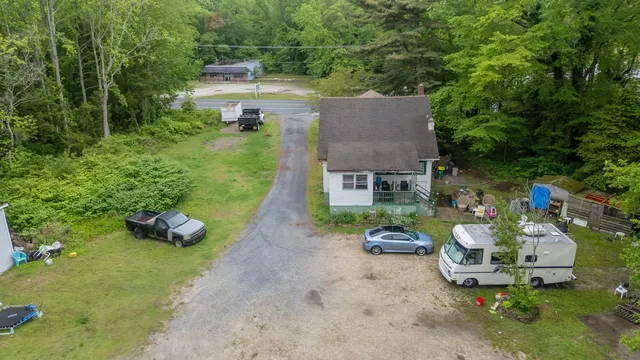 a view of a house with backyard and trees