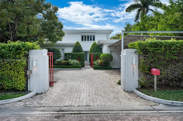 a view of a house with a yard and plants