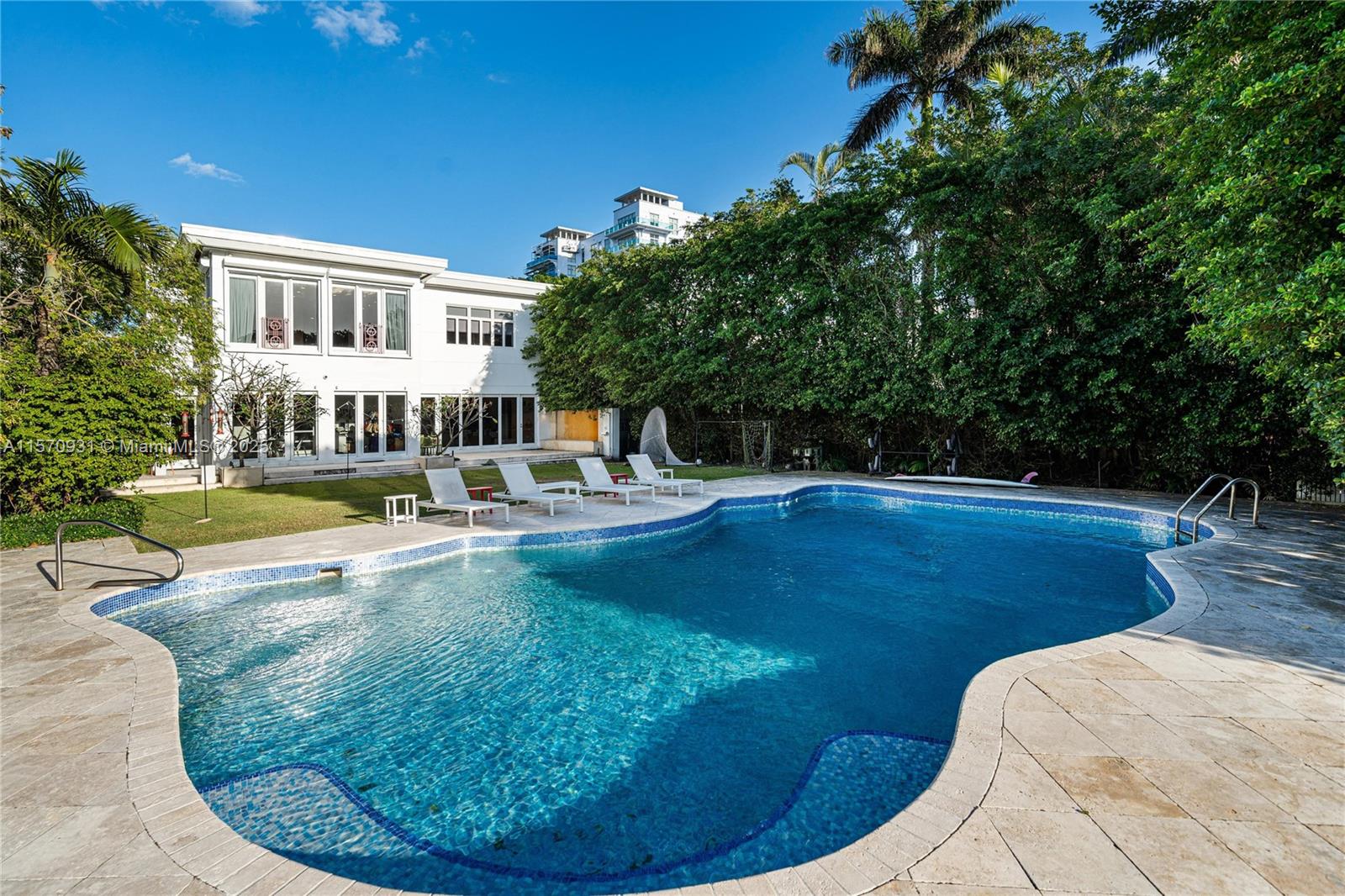 6320 Allison Road Miami Beach, FL 33141 - Photo 2 of 60 a view of a swimming pool with a sitting space