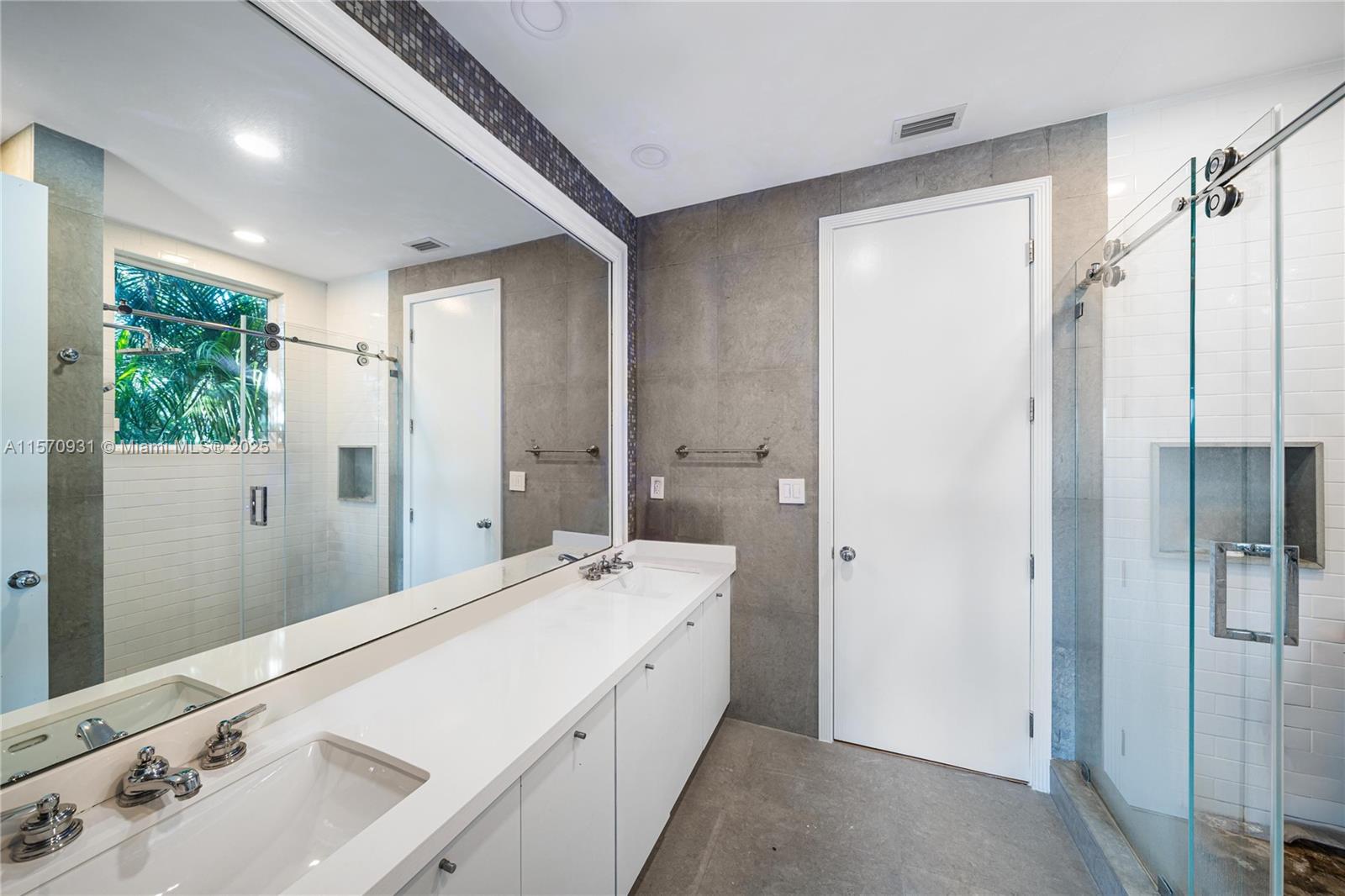 6320 Allison Road Miami Beach, FL 33141 - Photo 32 of 60 a spacious bathroom with a shower sink and mirror