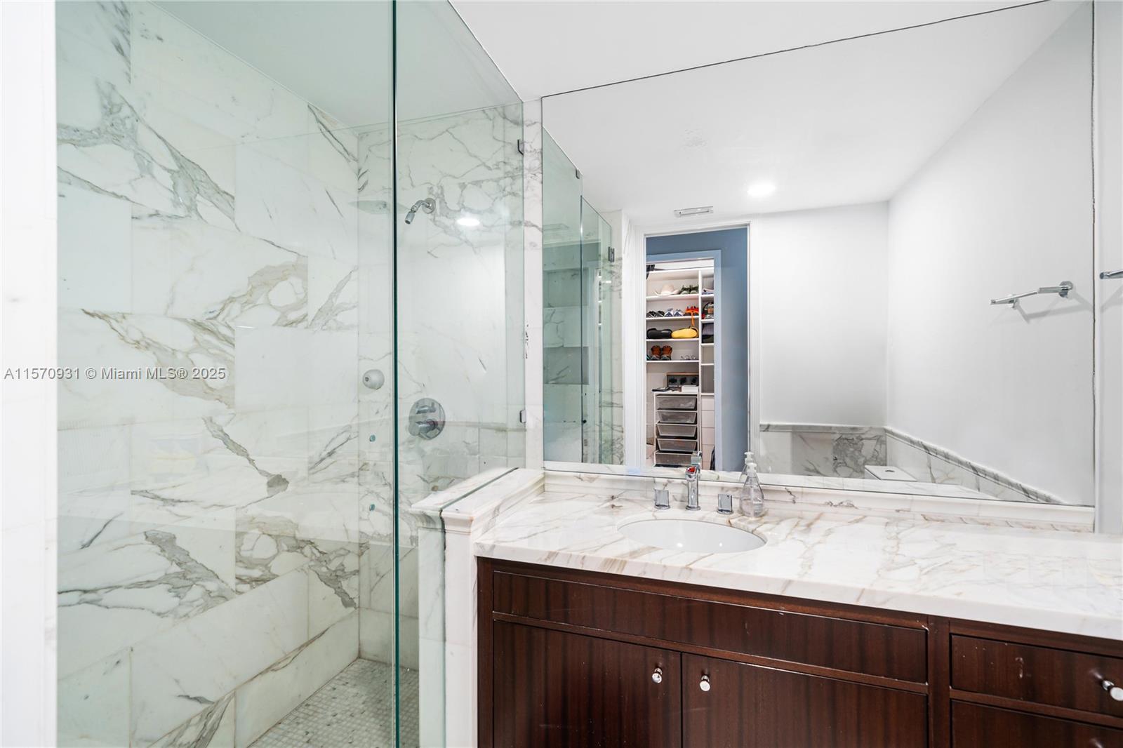 6320 Allison Road Miami Beach, FL 33141 - Photo 35 of 60 a bathroom with a granite countertop sink and a mirror