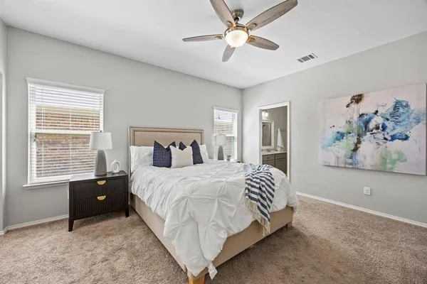 a bedroom with a bed and a painting on the wall
