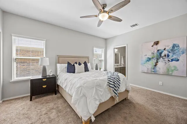 a bedroom with a bed and a painting on the wall