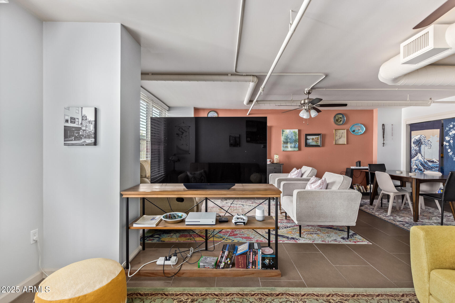 535 West Thomas Road, Unit 313 Phoenix, AZ 85013 - Photo 11 of 31 a living room with furniture a flat screen tv and a wall painting