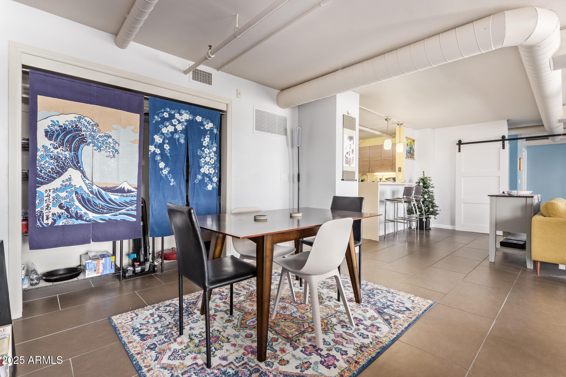 535 West Thomas Road, Unit 313 Phoenix, AZ 85013 - Photo 17 of 31 a dining room with chandelier and wooden floor