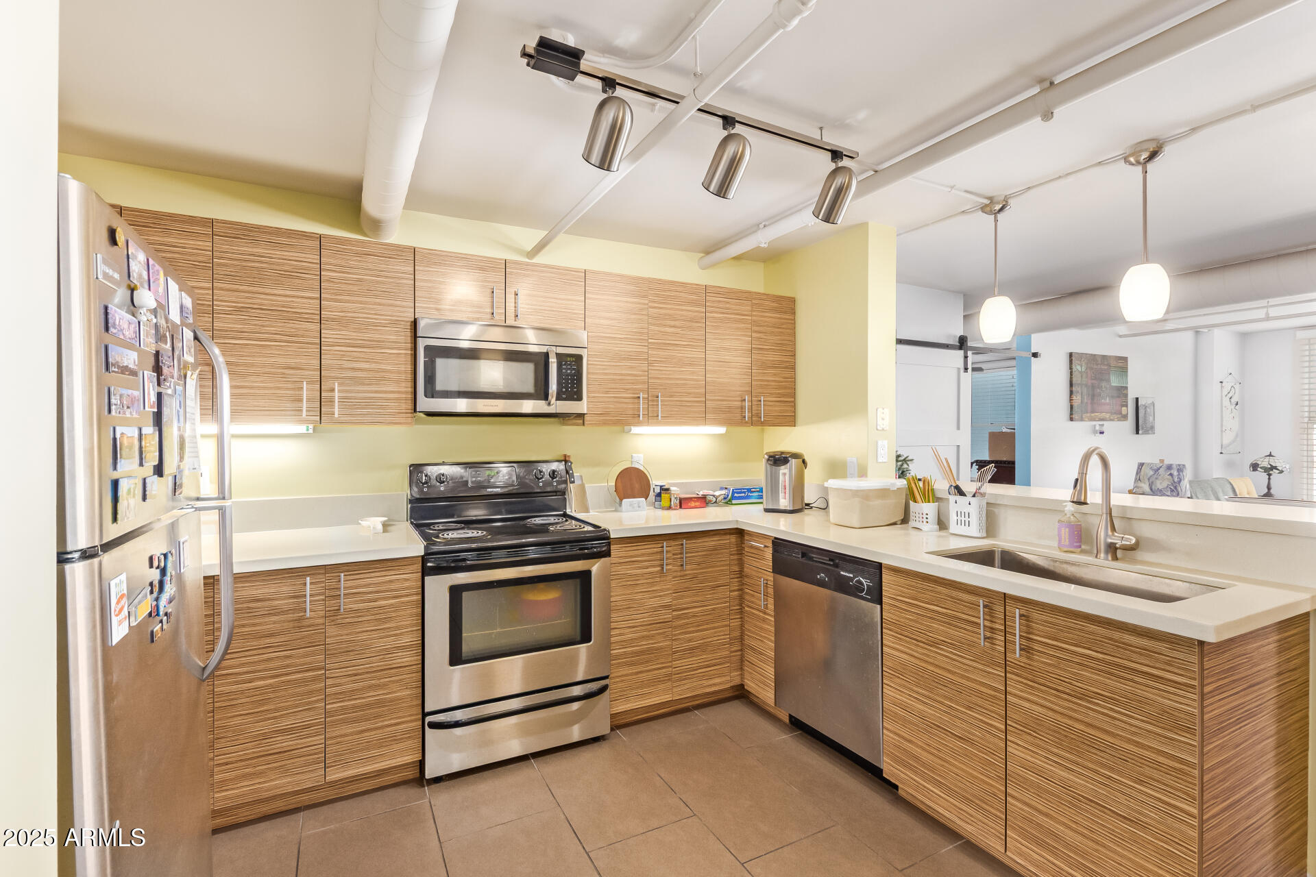 535 West Thomas Road, Unit 313 Phoenix, AZ 85013 - Photo 19 of 31 a kitchen with stainless steel appliances granite countertop a sink a stove and cabinets