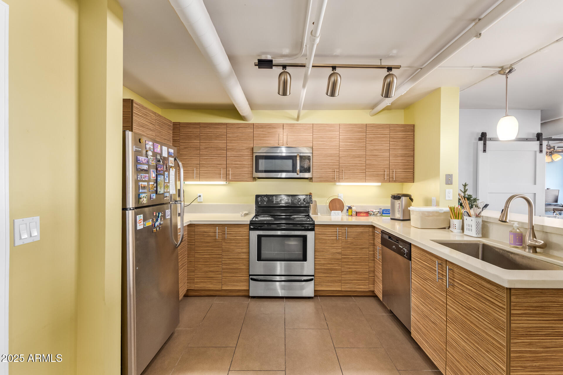 535 West Thomas Road, Unit 313 Phoenix, AZ 85013 - Photo 20 of 31 a kitchen with stainless steel appliances granite countertop a stove and a refrigerator