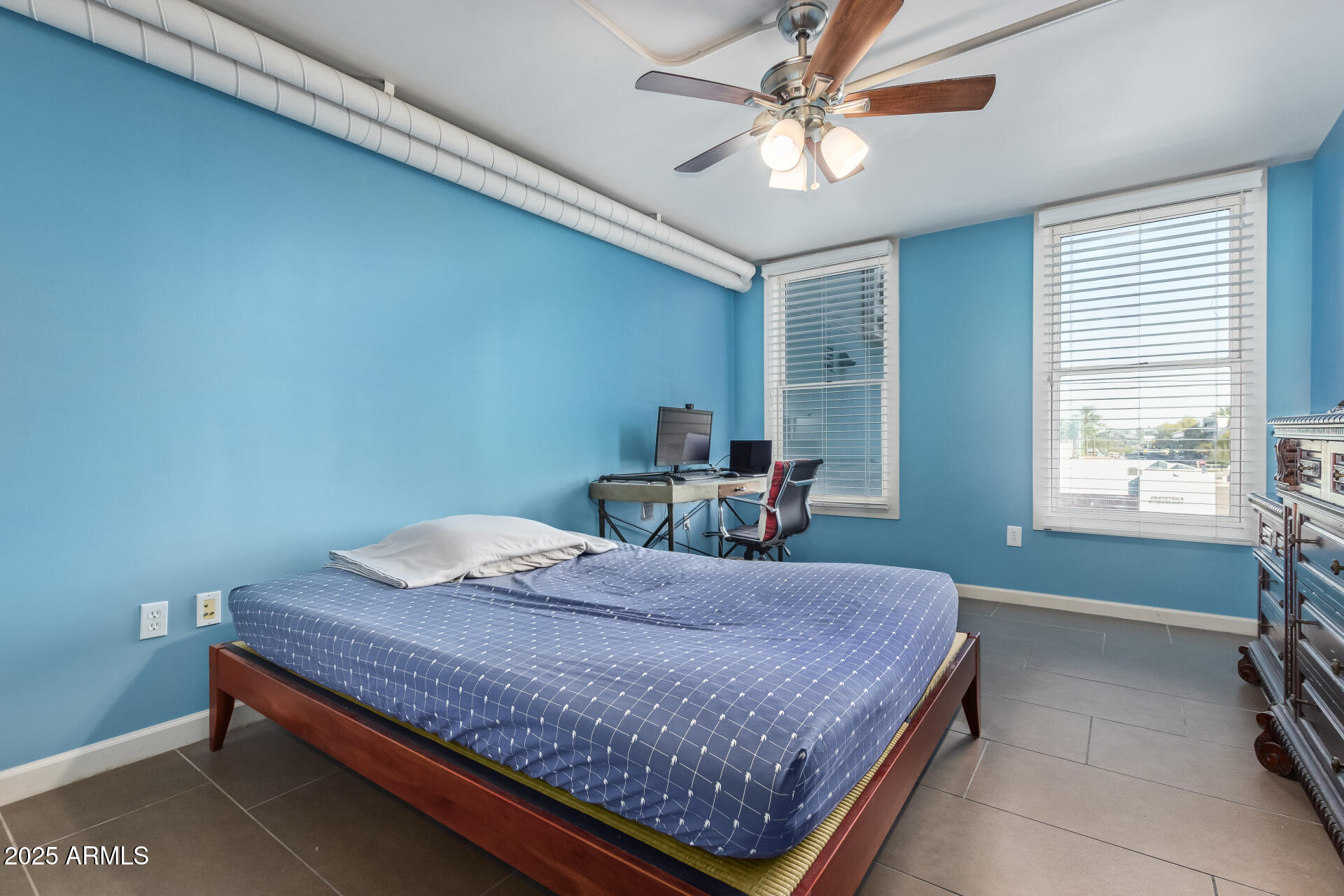 535 West Thomas Road, Unit 313 Phoenix, AZ 85013 - Photo 25 of 31 a bedroom with a bed and window