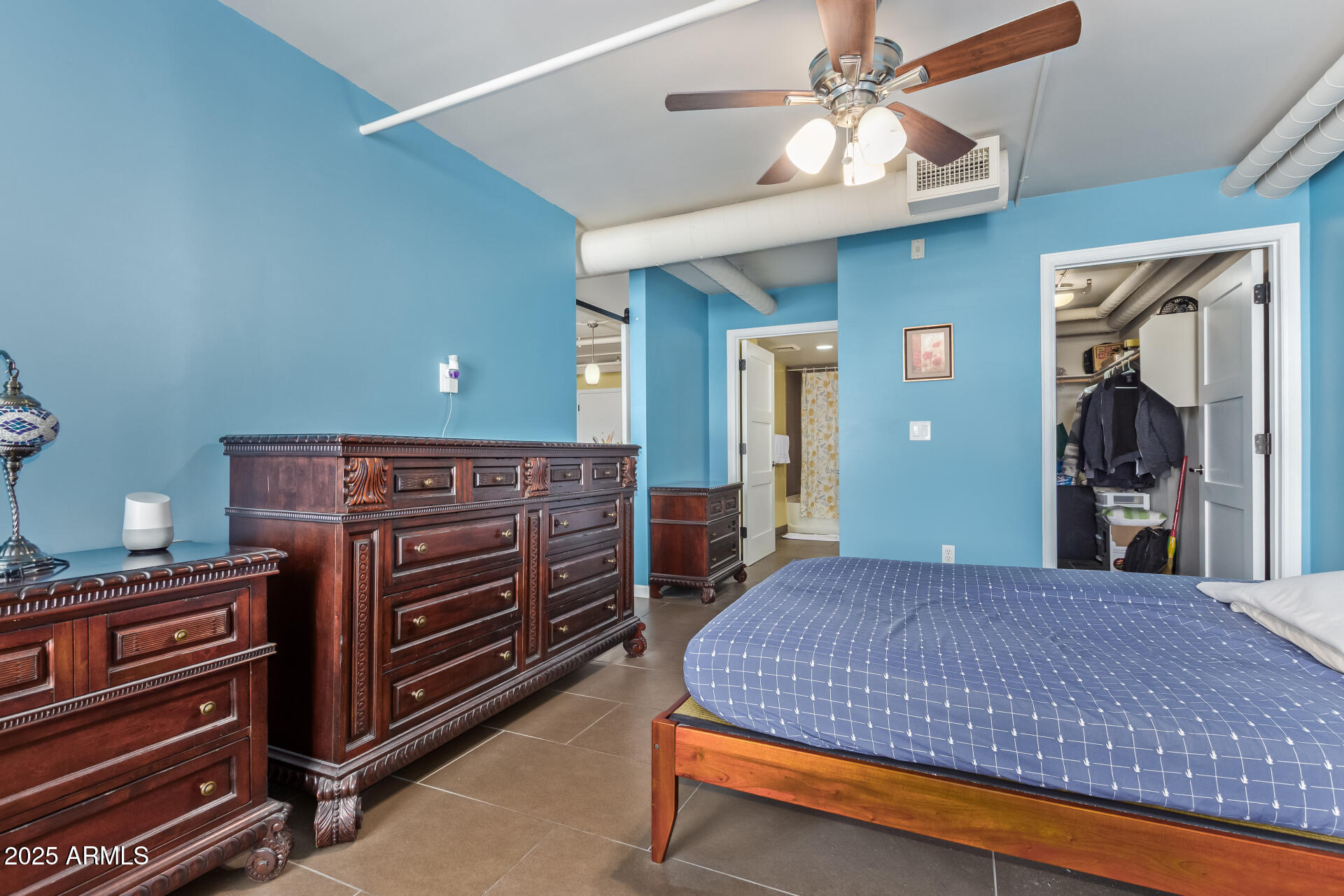 535 West Thomas Road, Unit 313 Phoenix, AZ 85013 - Photo 27 of 31 a bedroom with a bed and a chandelier
