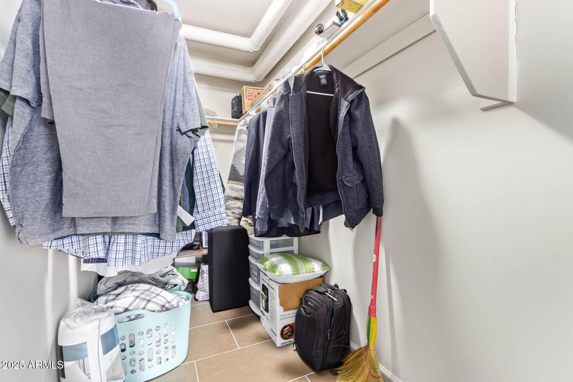 535 West Thomas Road, Unit 313 Phoenix, AZ 85013 - Photo 30 of 31 a view of walk in closet with clothes