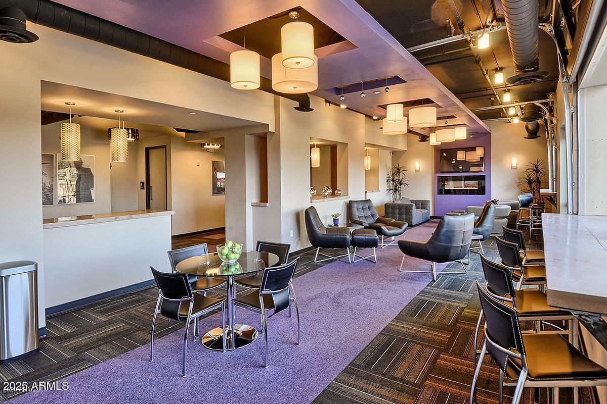 535 West Thomas Road, Unit 313 Phoenix, AZ 85013 - Photo 5 of 31 a living room with furniture a table and chairs