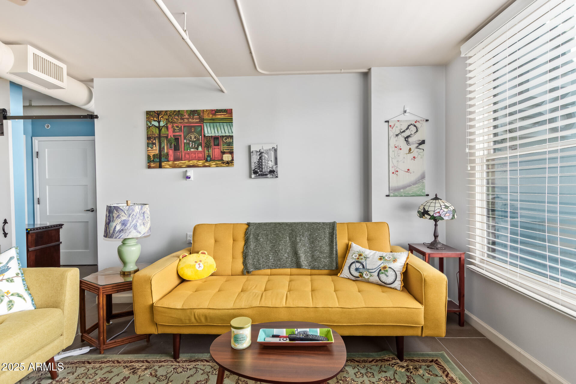 535 West Thomas Road, Unit 313 Phoenix, AZ 85013 - Photo 9 of 31 a living room with patio furniture and a window
