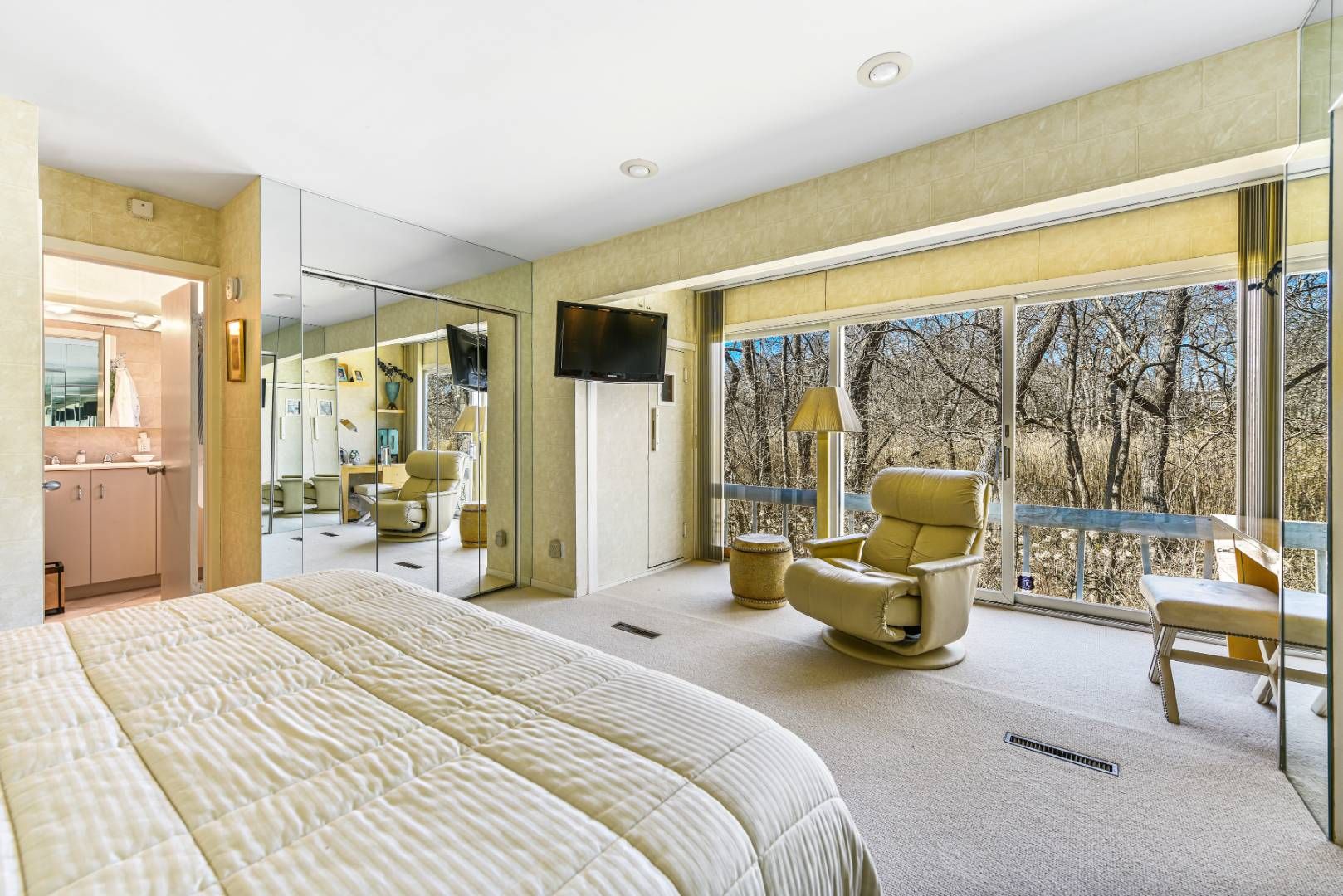 45 South Country Road Westhampton, NY 11977 - Photo 16 of 22 a bedroom with a bed and large windows