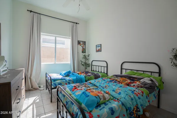 a bedroom with two beds and a table