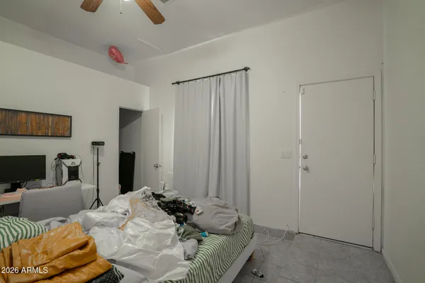 a bedroom with bed and a couch