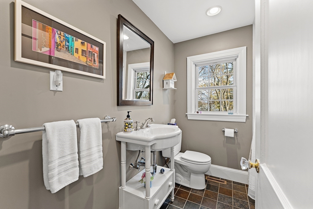 1052 Greendale Avenue Needham, MA 02492 - Photo 17 of 42 a bathroom with a toilet sink and mirror