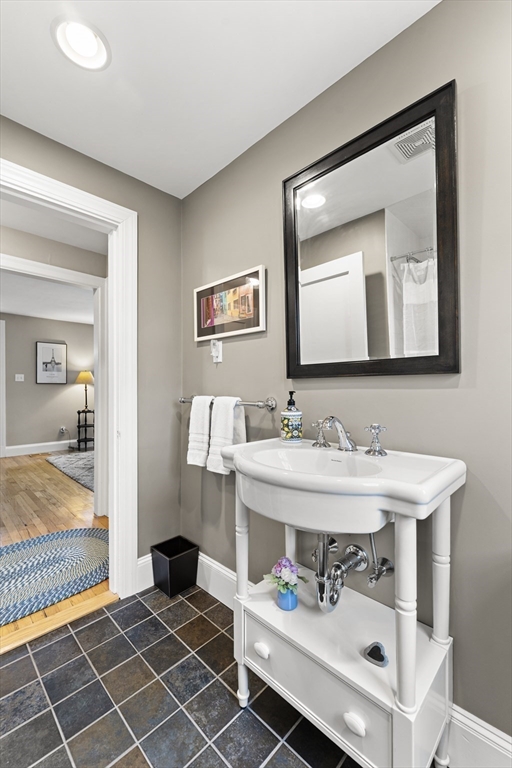 1052 Greendale Avenue Needham, MA 02492 - Photo 18 of 42 a bathroom with a sink and a mirror